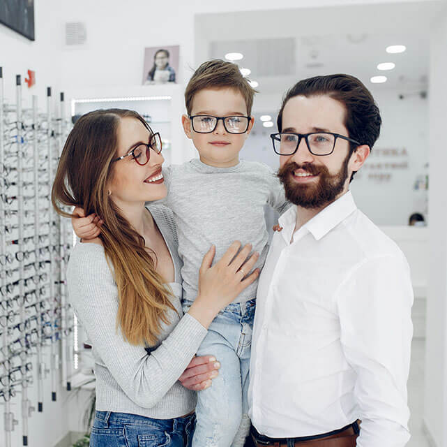family wearing eyeglasses at an optical shop