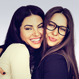 two friends showing off glasses smiling 2