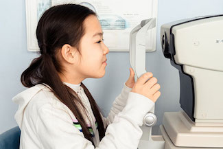 young Asian girl getting an eye exam