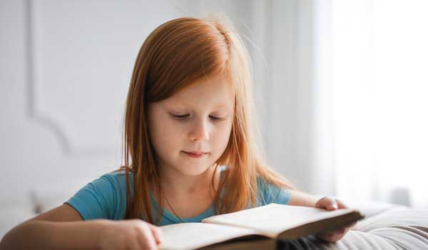 girl in blue t shirt reading book 3755619