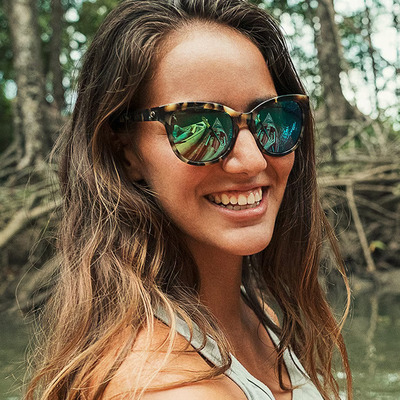 happy woman wearing vintage tortoise costa sunglasses