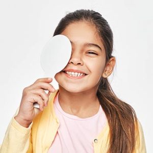 Mixed Race Female Kid Having Eye Exam With One Eye Covering Usin