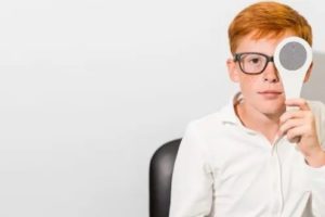 boy with glasses covering one eye