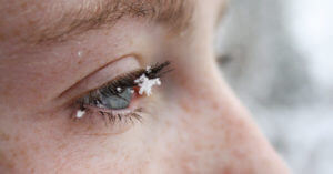 Close Up Of Teenage Girl With Snow On Eyebrow