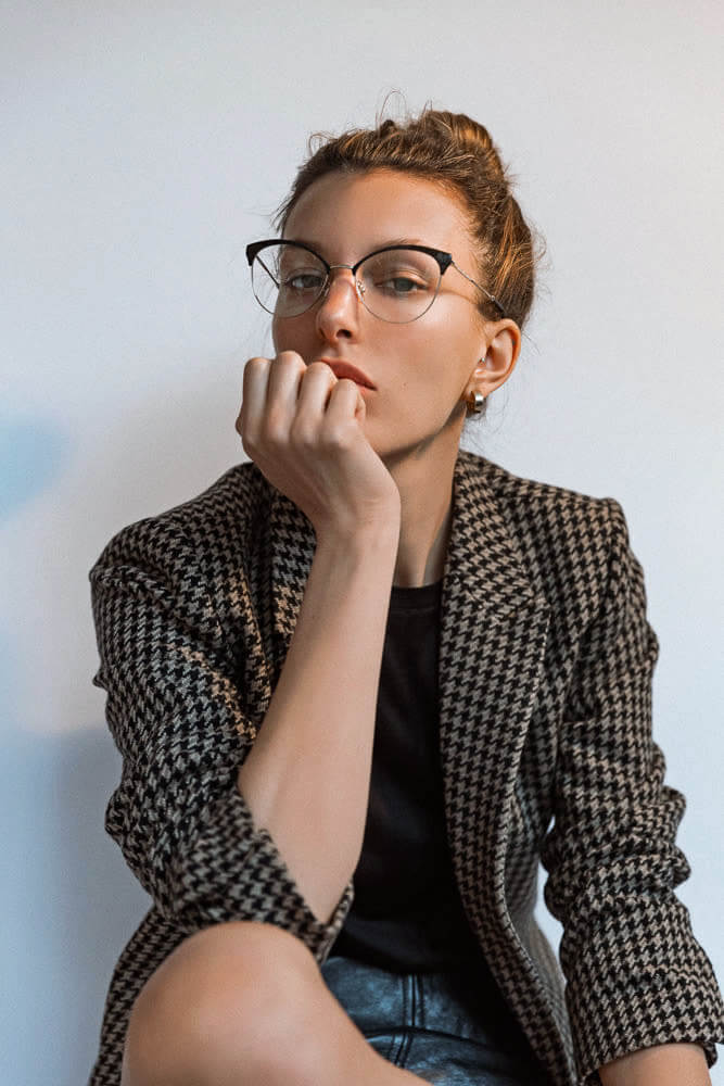 Woman wearing round designer eyeglasses
