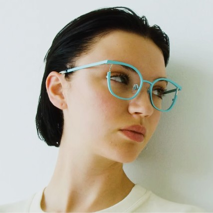 woman wearing cyan face a face eyeglasses