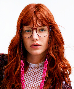 woman red hair wearing gotti eyeglasses 250x300