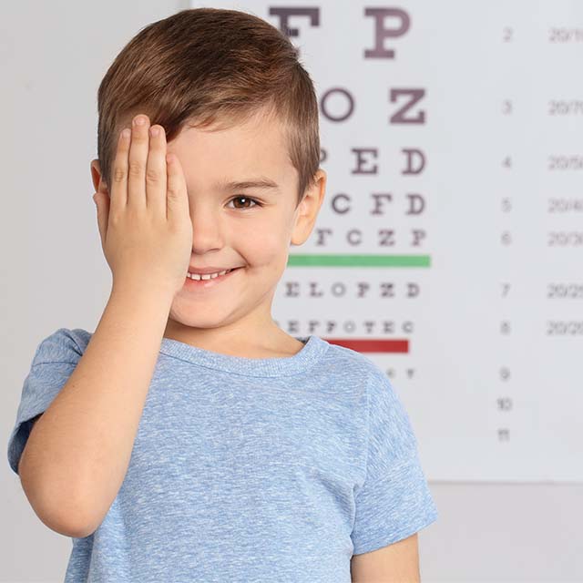 Young boy looking at eye chart