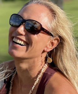 blong woman smiling wearing maui jim sunglasses