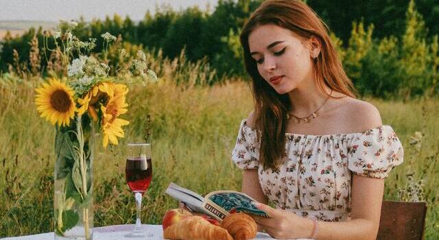 red hair woman wearing a book outdoors