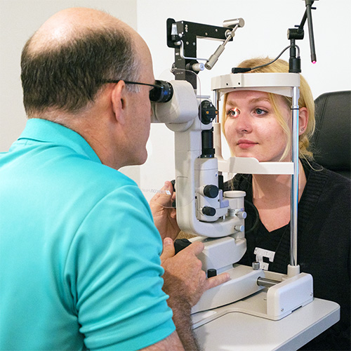 Eye doctor performing an Eye Exam in the optometrist office