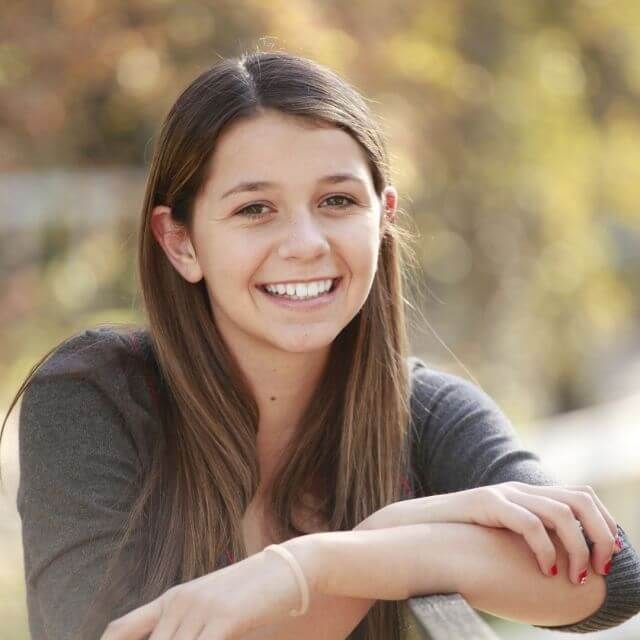 teen girl smiling brunette contacts ortho k 640px