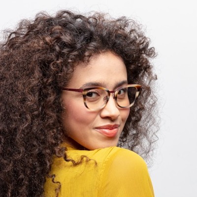 woman curly hair wearing bevel eyeglasses
