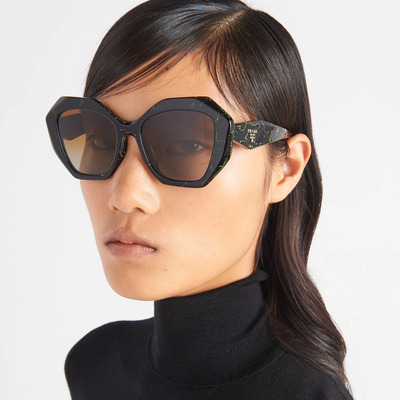 asian woman wearing black prada sunglasses