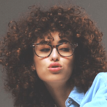 woman curly hair wearing ray ban eyeglasses