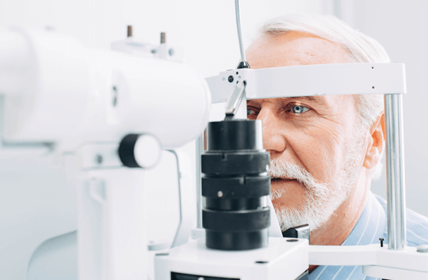 Older gentleman undergoing eye exam at eye clinic