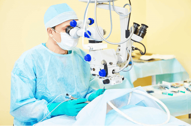male eye doctor performing laser eye surgery with vanilla lighting in background
