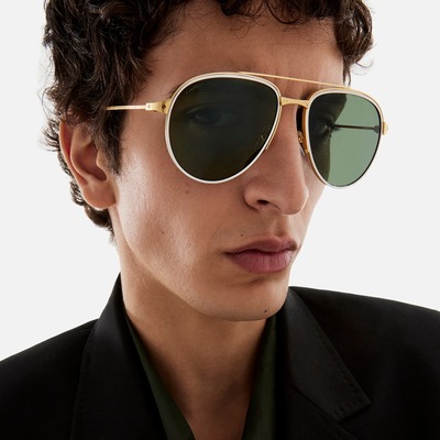 man wearing green tinted cartier sunglasses