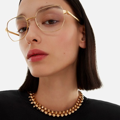 woman wearing gold rimed cartier eyeglasses