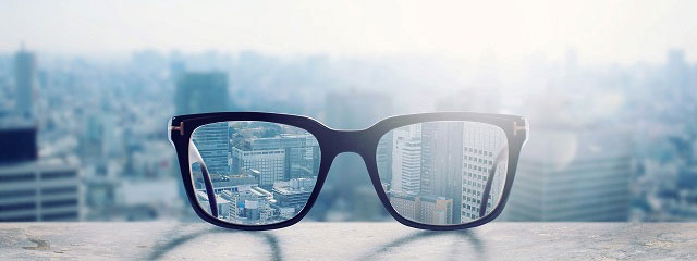 eyeglasses on building ledge seeing city 2