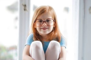 child girl redhead smiling glasses blue ballet dress e1611740044685.jpg