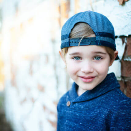 Boy wearing blue baseball cap
