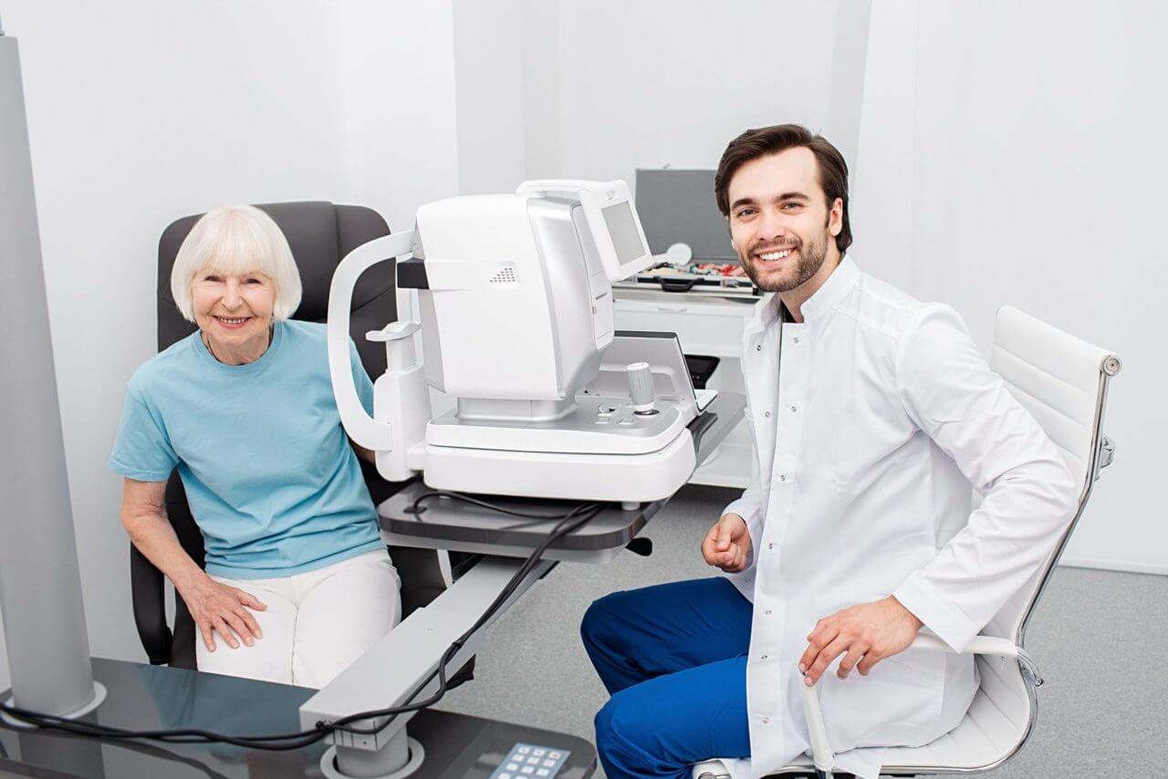 Smiling Optometrist With His Senior Patient, Friendly looking At