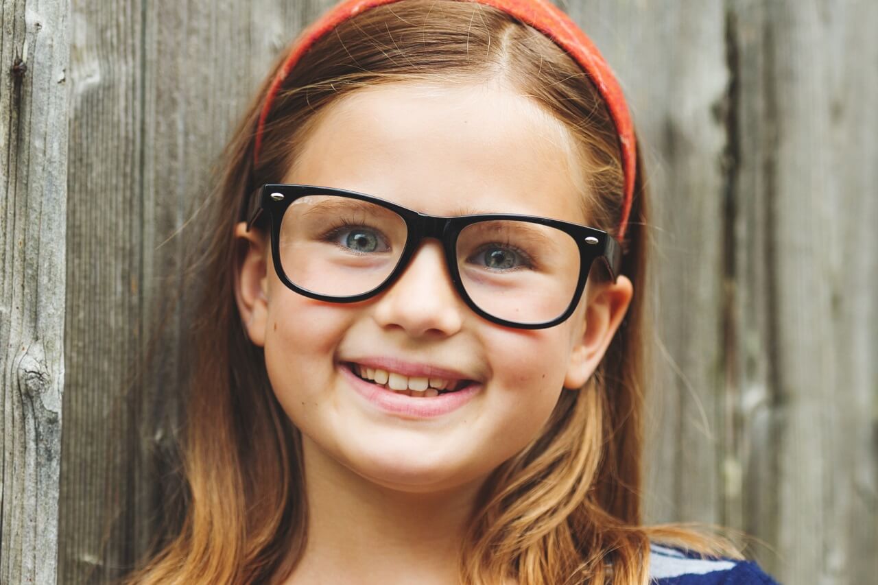 cute young girl black eyeglasses orange headband