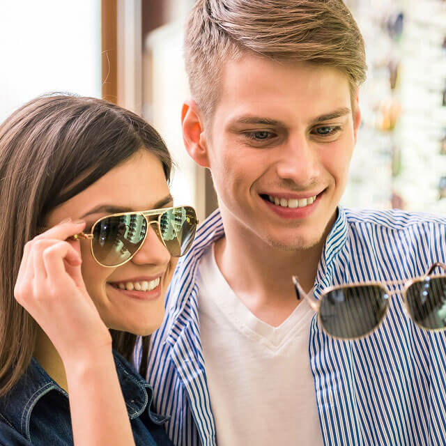young couple buying sunglasses opt