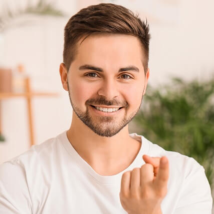handsome man holding contact on finger