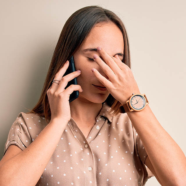 woman with dry eye talking on the phone