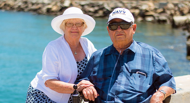 elderly couple with low vision glasses sitting outside