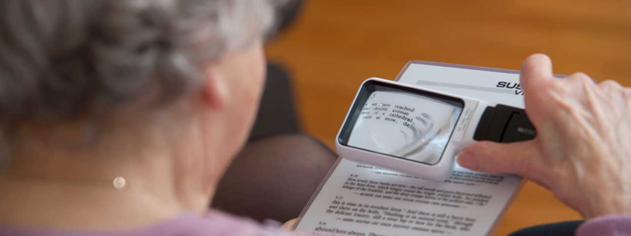 Woman using magnifier to read