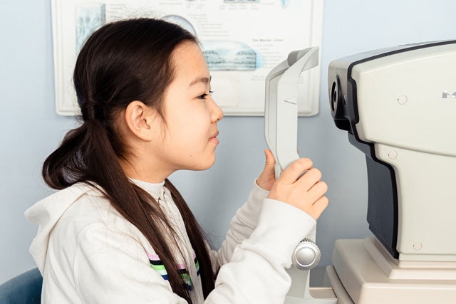 young Asian girl getting an eye exam 640