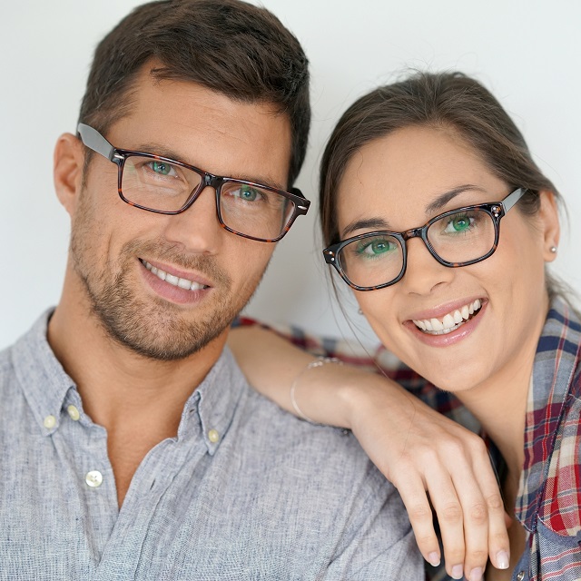 young couple modeling eyeglasses