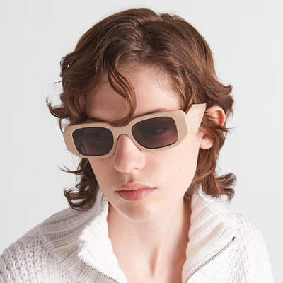 woman wearing white prada sunglasses
