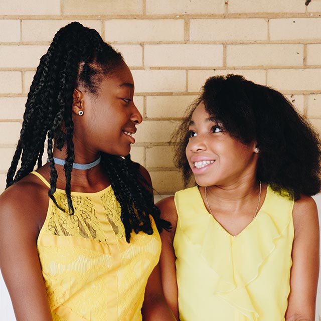 smiling girls in yellow dresses