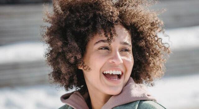 happy woman curly hair winter outdoors