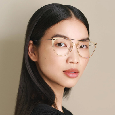asian woman wearing gold lindberg eyeglasses