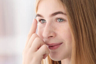 teenager applying contact lens