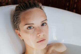 woman wearing contact lenses in the bathtub