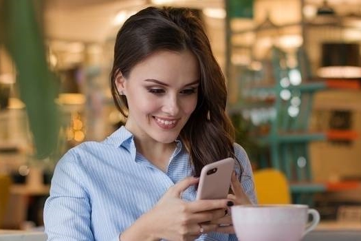 happy woman browsing smartphone