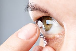 putting on contact lens