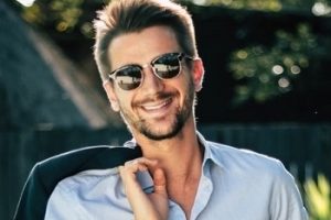 man smiling wearing stylish sunglasses 350px