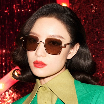 asian woman wearing dark tinted gucci sunglasses