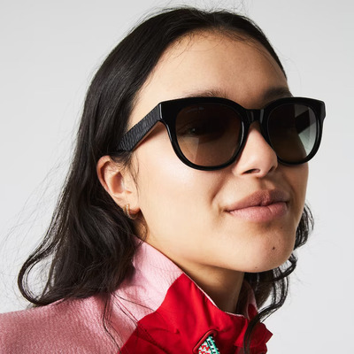 asian woman wearing black lacoste sunglasses