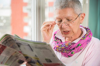 senior woman reading newspaper