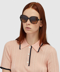 woman wearing coach sunglasses