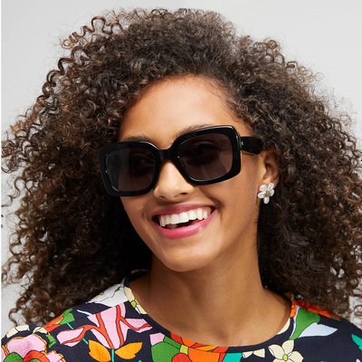 woman curly hair wearing kate spade sunglasses
