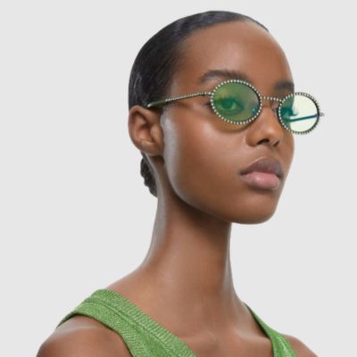 woman wearing green swarovski sunglasses